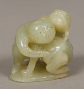 A Chinese carved jade figural group Modelled as a man and a dog-of-fo on a lily pad form base. 4.