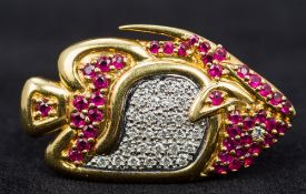 An 18 ct gold diamond and ruby brooch Formed as a tropical fish. 3.5 cm long.