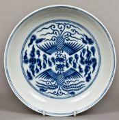 A Chinese blue and white porcelain dish Decorated with phoenixes amongst stylised clouds,
