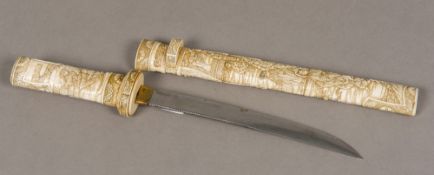 A 19th century Japanese carved bone tanto The handle and sheath well carved in the round with