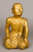A Sino-Tibetan carved giltwood figure of a monk Modelled kneeling in traditional robes. 37 cm high.