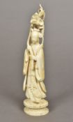 A late 19th/early 20th century Chinese carved ivory figure of Guanyin Holding a lotus flower,