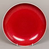 A Chinese porcelain dished plate With allover sang de boeuf glazed,