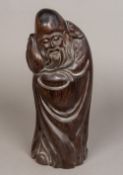 A Chinese carved hardwood figure of Shou Lao Typically worked holding a peach. 38 cm high.