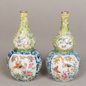 A pair of Chinese porcelain double gourd vases Each painted with bird vignettes on a lotus