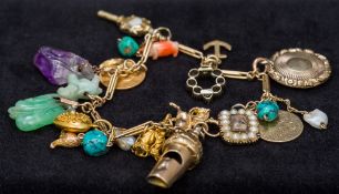 An interesting charm bracelet The unmarked gold bracelet set with various gold,