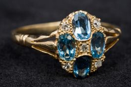 An unmarked 18 ct gold, diamond and aquamarine ring Of domed target form, with pieced shoulders. 1.