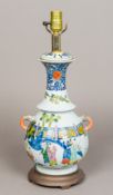 A Chinese porcelain table lamp The twin handled vase decorated with boys at play within a fenced