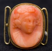 A small 19th century carved coral cameo Set in an unmarked gold clasp setting. 2 cm high.