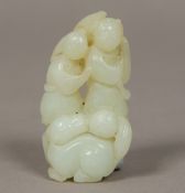 A Chinese carved mutton fat jade group Worked as a temple lion before a pair of figures. 7.