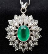 A platinum, diamond and emerald set pendant Of pierced cluster form, mounted a platinum chain.