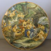 An antique Cantagalli charger Decorated with cherubs and Bacchic figures,