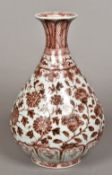 A Chinese porcelain baluster vase Decorated in iron red with lotus strapwork. 31.5 cm high.