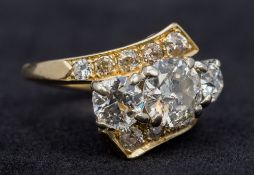 A 14K gold diamond set three stone ring The central stone approximately 1.