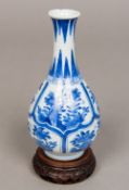 A Chinese Kangxi period blue and white porcelain bottle vase Worked with flora and rockwork