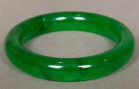 A Chinese carved spinach jade bangle