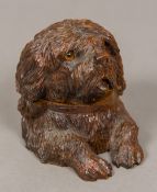 A Black Forest carved wooden inkwell Formed as a dog, the hinged head with glass inset eyes,