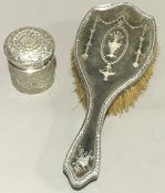 A silver topped jar and a silver and tortoiseshell brush