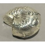 A silver box in the form of a shell