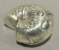 A silver box in the form of a shell