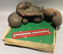 Two pairs of vintage boxing gloves and a boxed bar skittles game