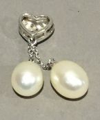 An 18 ct gold diamond and pearl pendant