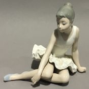 A Nao figure of a ballerina at rest