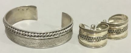 A silver bracelet and earring set