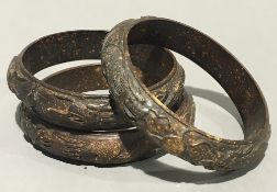 Three Chinese carved bangles