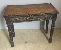 A Victorian carved oak card table