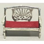 A miniature silver sofa