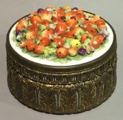 A brass mounted porcelain box and cover,