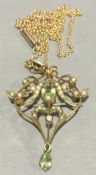 An Edwardian 9 ct gold peridot and seed pearl pendant on an unmarked chain