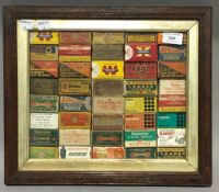 A framed collection of ammunition boxes