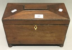 A Victorian mahogany sarcophagus tea caddy