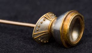 An unusual gold and silver stickpin of a knight's helmet