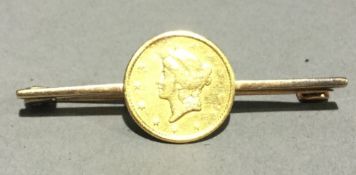 A gold one dollar coin set brooch