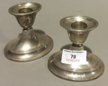 A pair of silver dwarf candlesticks