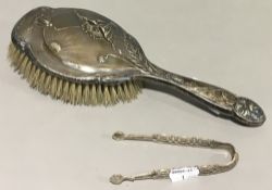 A silver Art Nouveau brush and silver tongs