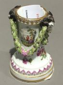 A Meissen porcelain spill vase, worked with rams' heads and swags, painted with figural vignettes,