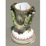 A Meissen porcelain spill vase, worked with rams' heads and swags, painted with figural vignettes,