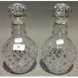 A pair of silver mounted cut glass decanters, hallmarked London 1989,