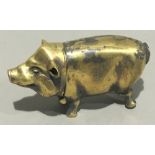 A brass vesta formed as a pig