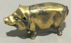 A brass vesta formed as a pig