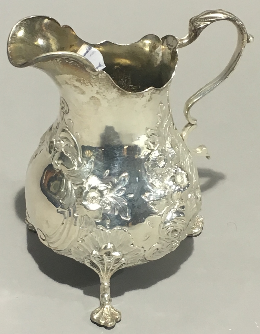 An embossed silver cream jug (6 troy ounces)