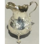 An embossed silver cream jug (6 troy ounces)