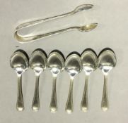A set of six silver teaspoons and tongs