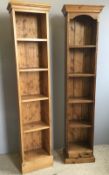 A pair of narrow pine bookcases