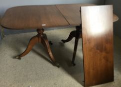 A mahogany reproduction twin pillar dining table