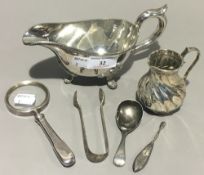 A silver magnifying glass, a silver caddy spoon,